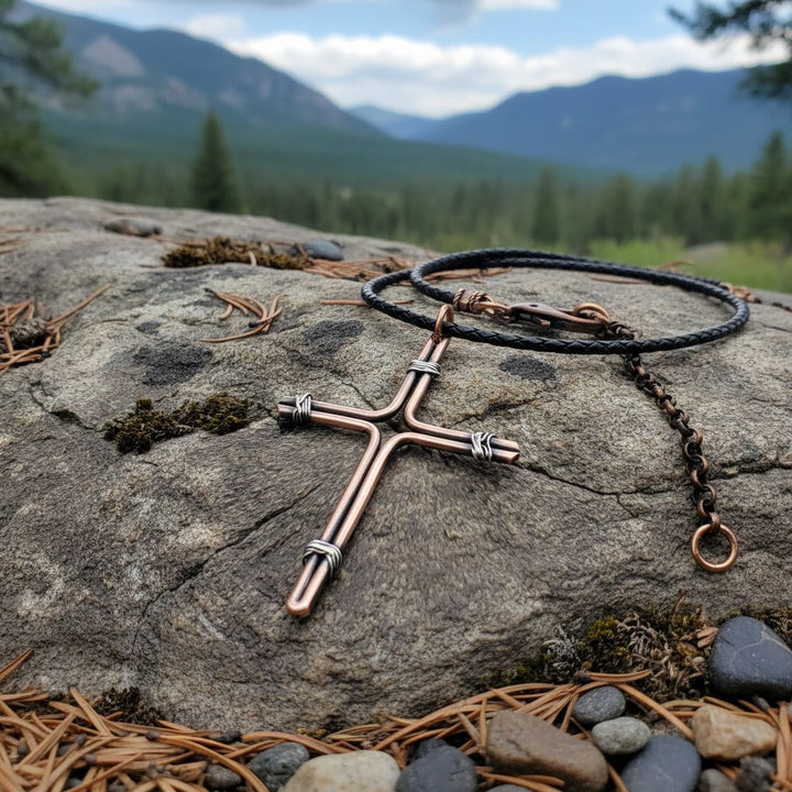 Handmade Large Copper and Silver Wire Cross Necklace for Men on a rock in nature