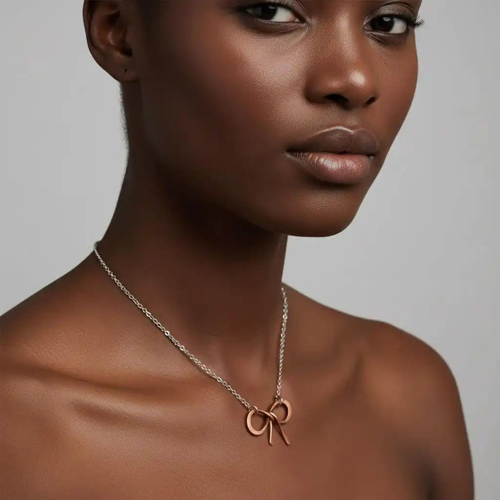Wire Wrapped Copper Bow Tie Silver Chain Necklace modeled by a woman showcasing its elegant design.