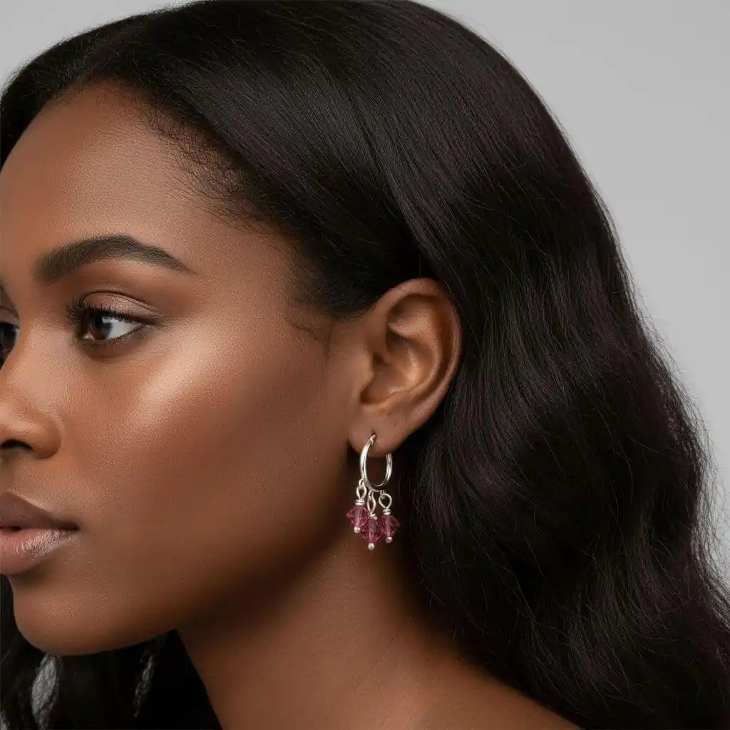 Model wearing Mini Sterling Silver Hoop Pink Crystal Dangle Earrings showcasing elegant design and sparkly pink crystals.