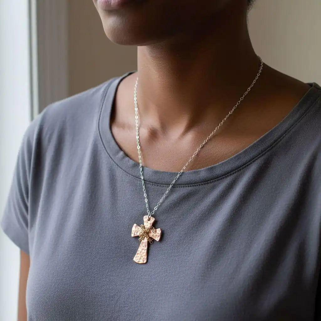 Chained Hammered Copper Cross Necklace For Him Or Her worn by a person, showcasing its unique hammered design and craftsmanship.
