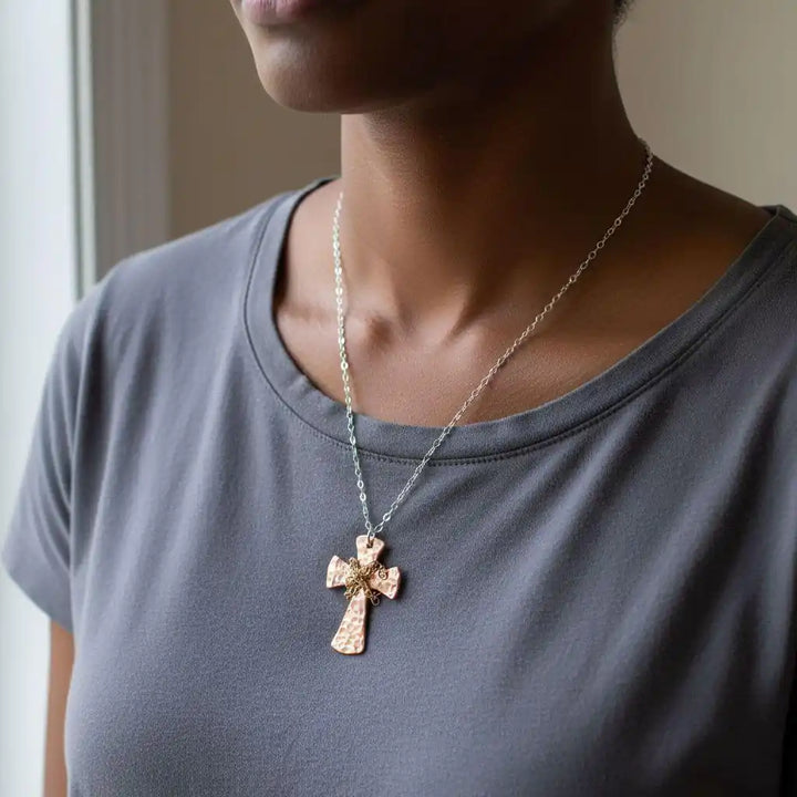 Chained Hammered Copper Cross Necklace For Him Or Her worn by a person, showcasing its unique hammered design and craftsmanship.