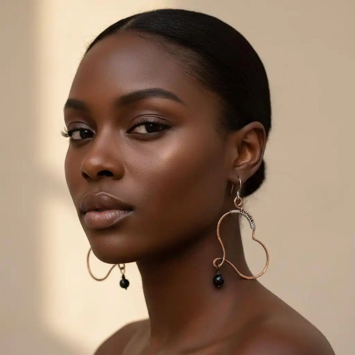 Sculpted Copper Butterfly Wing Abuse Survivor Earrings worn by a model, showcasing unique design and Swarovski crystal dangles.