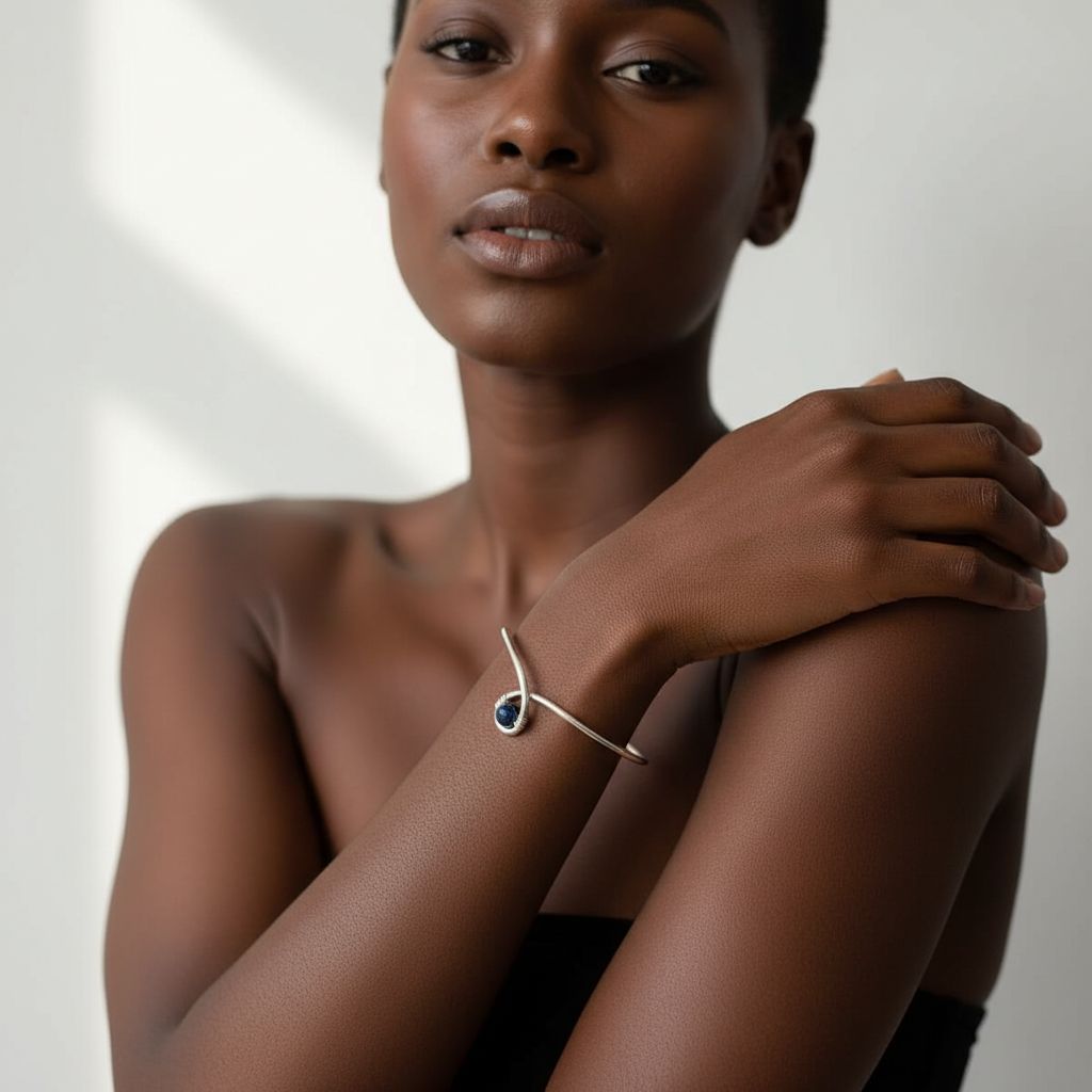 Silver Blue Bead Child Abuse Awareness Ribbon Bangle worn by a model showcasing its elegant design.