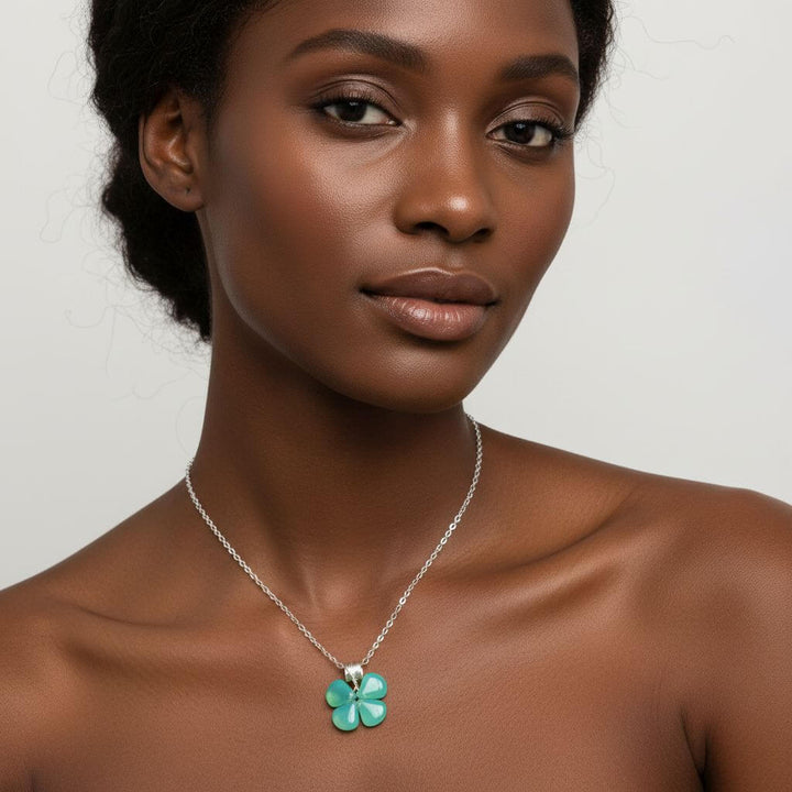 Model wearing a mint green beaded clover necklace with a silver chain, showcasing a stylish and elegant look.