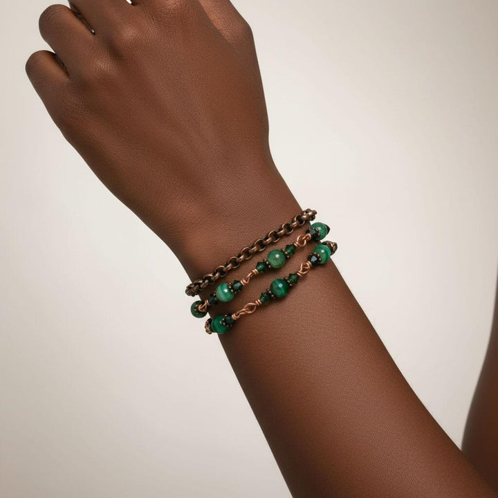 Hand wearing a 24 inches emerald agate wire wrapped necklace shown as a triple wrap bracelet with emerald-striped agate.