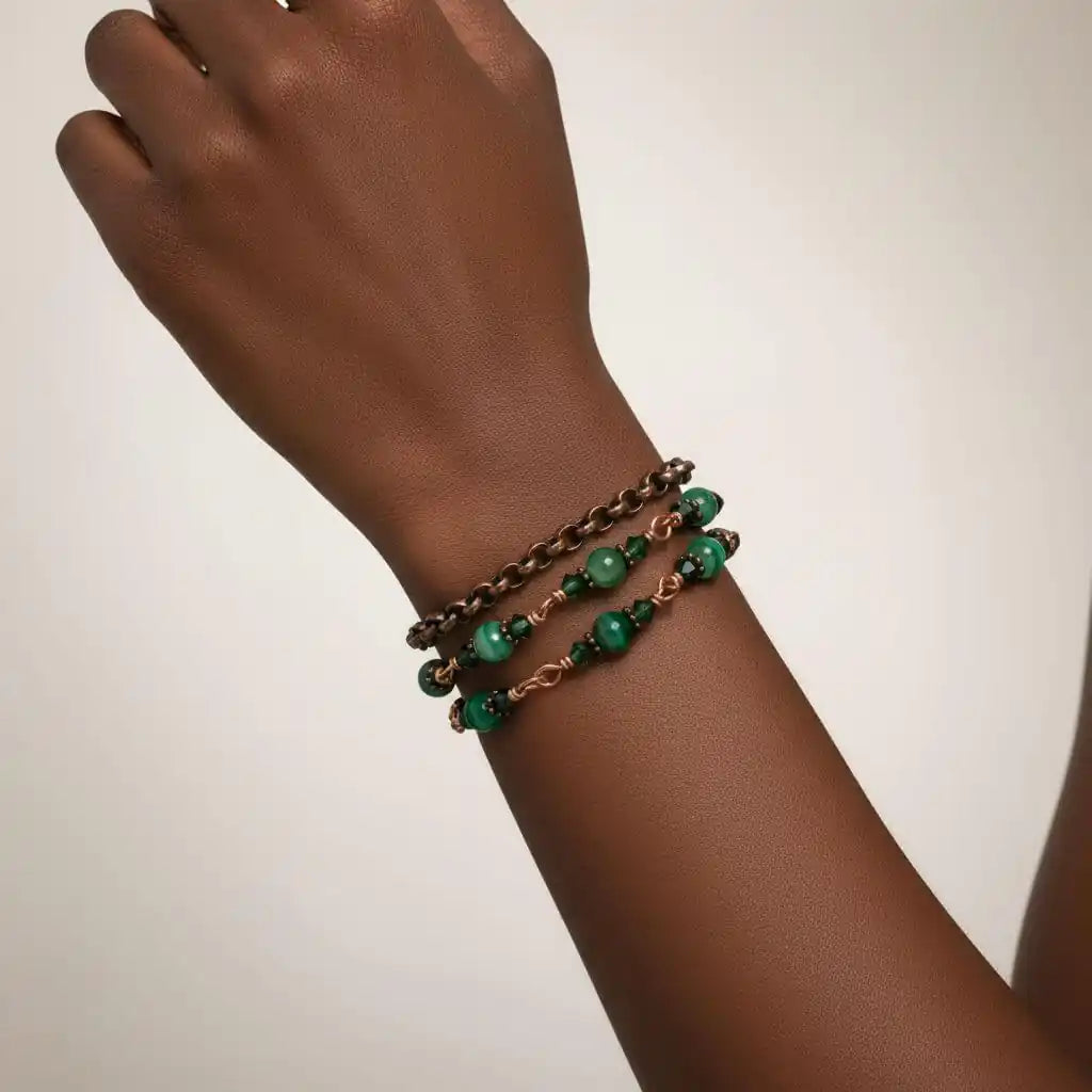 Hand wearing a 24 inches emerald agate wire wrapped necklace shown as a triple wrap bracelet with emerald-striped agate.