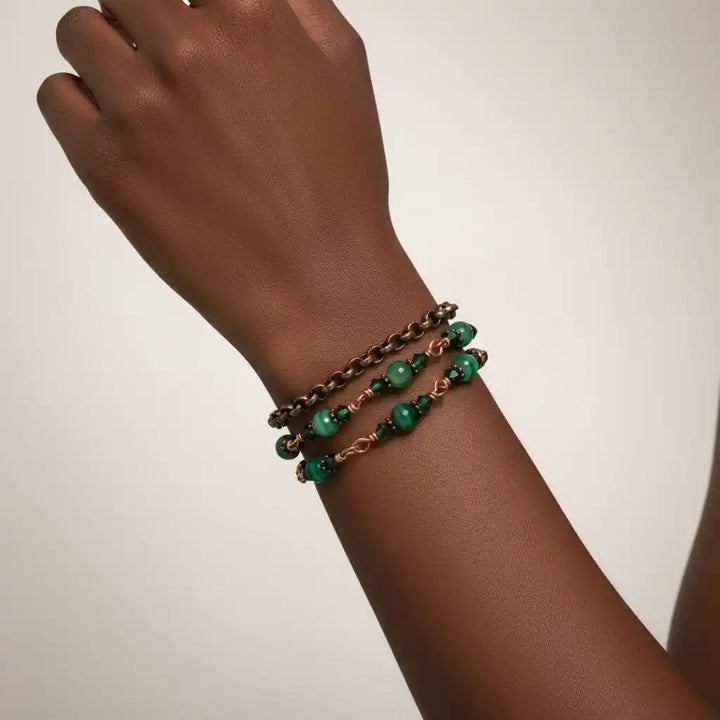 Hand wearing a 24 inches emerald agate wire wrapped necklace shown as a triple wrap bracelet with emerald-striped agate.