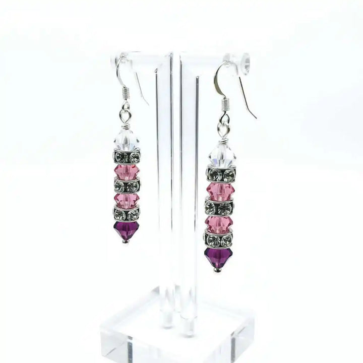 Hot Pink Ombre Stacked Crystal Sterling Silver Earrings displayed beautifully on a clear earring stand.