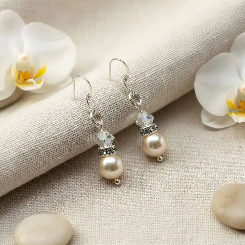 Various Color Swarovski Crystal Pearl Stack Earrings displayed with flowers for elegant occasions.