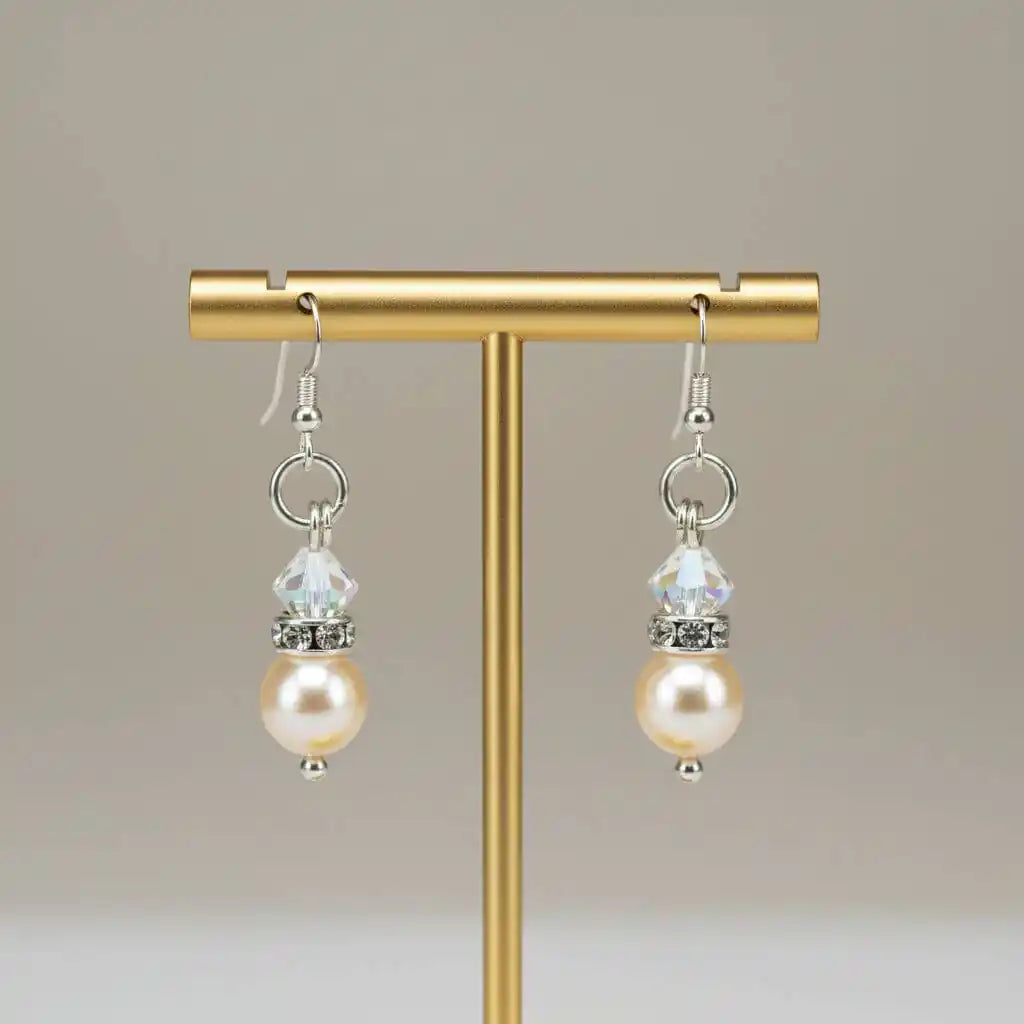 Various Color Swarovski Crystal Pearl Stack Earrings displayed on a stand with elegant design.
