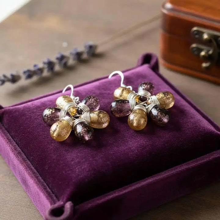 Purple and Yellow Flower Sterling Silver Earrings displayed on a purple velvet box.