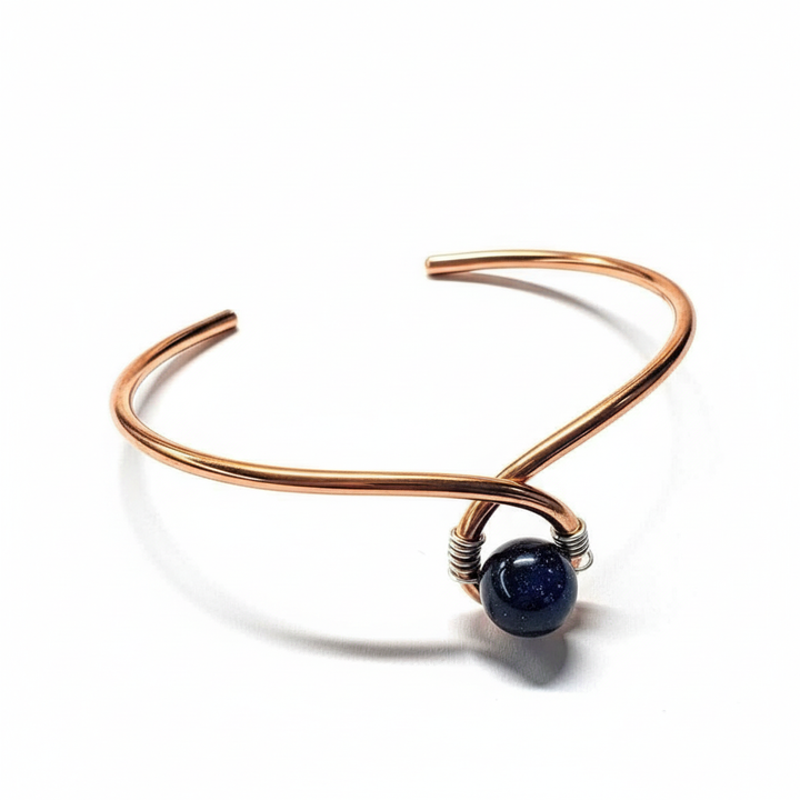 Handmade copper silver ribbon child abuse awareness teardrop bangle with blue goldstone bead white background