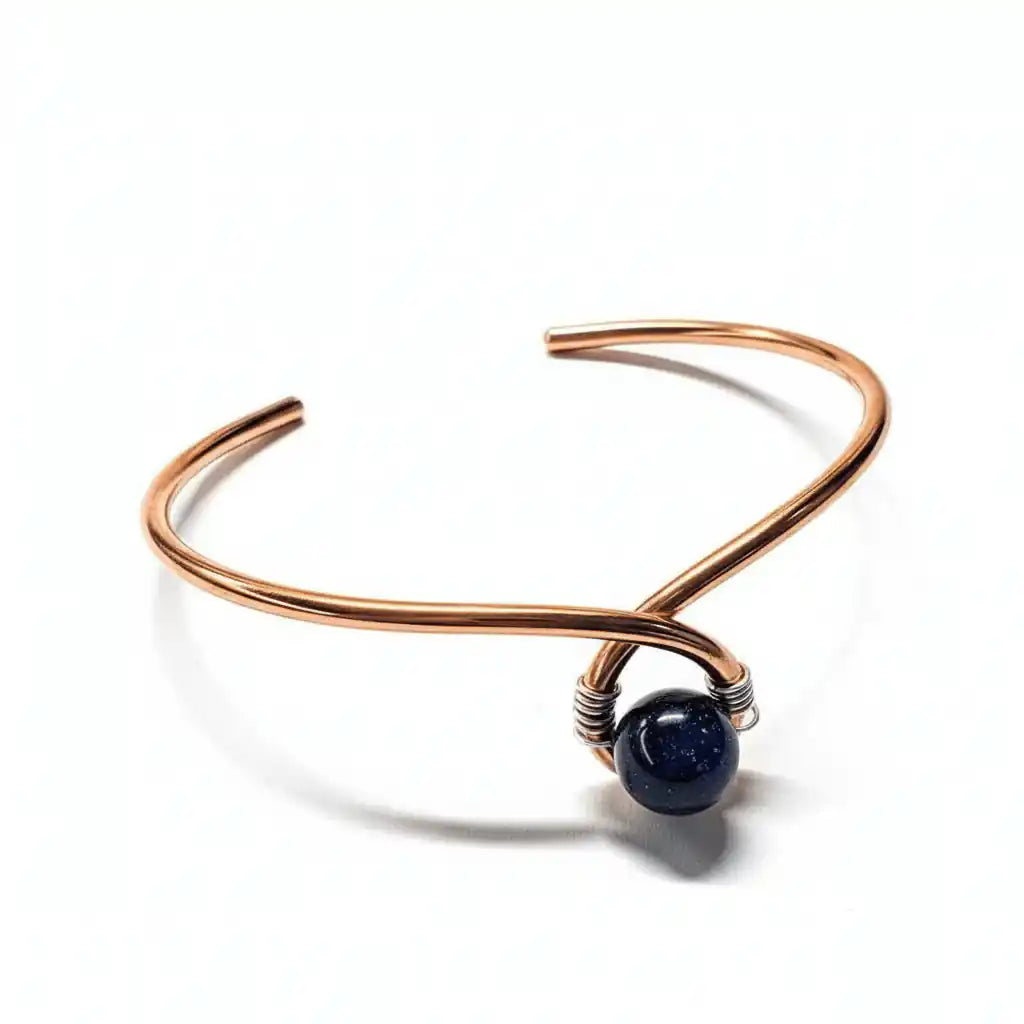 Handmade copper silver ribbon child abuse awareness teardrop bangle with blue goldstone bead white background