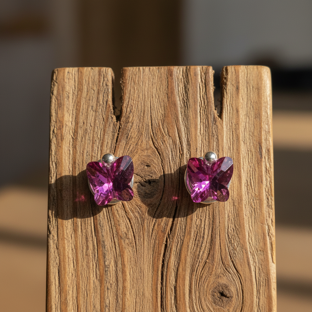 Fuchsia butterfly studs on wooden jewelry stand