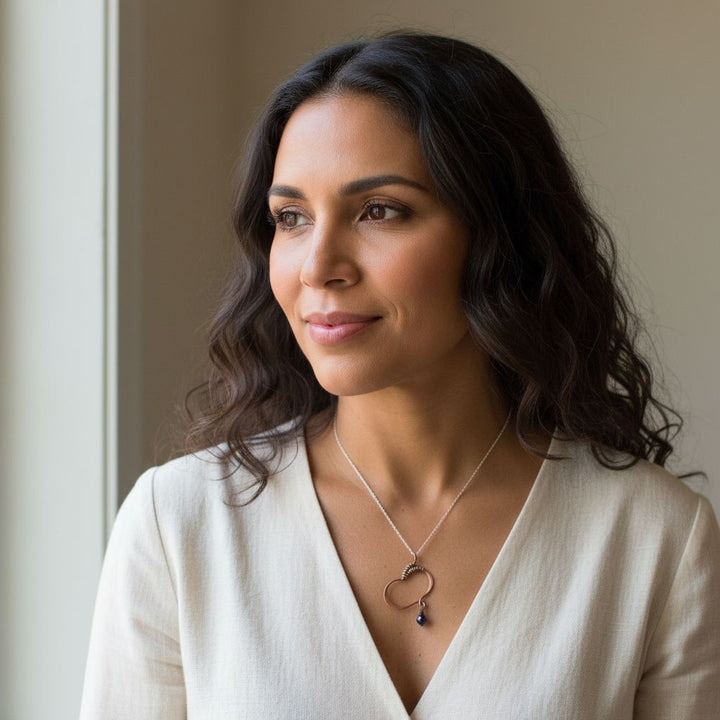 Hammered Copper Butterfly Wing Child Abuse Survivor Necklace on a model with a soft expression.