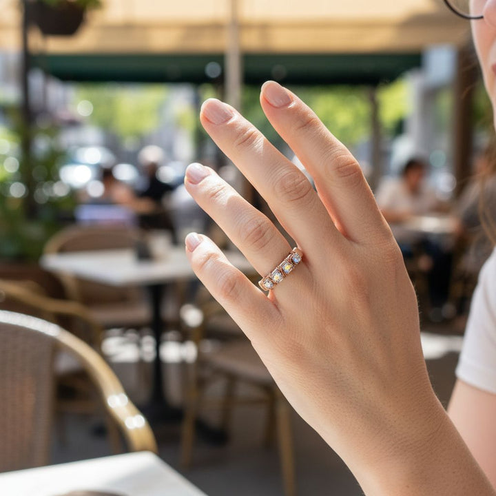 Rose Gold Filled Wire Wrapped Sparkly Crystal Bling Ring worn on a hand in a café setting, showcasing its glamorous design.