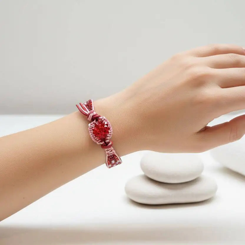 Leather Silk Bead Woven Crystal Button Bracelet worn on a wrist with stones in the background.