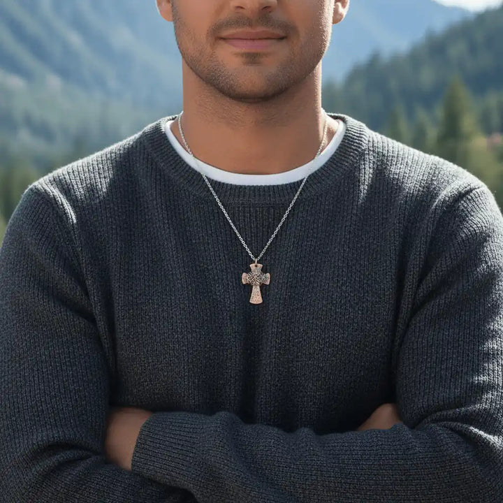 Chained Hammered Copper Cross Necklace For Him Or Her worn by a man outdoors with mountains in the background.