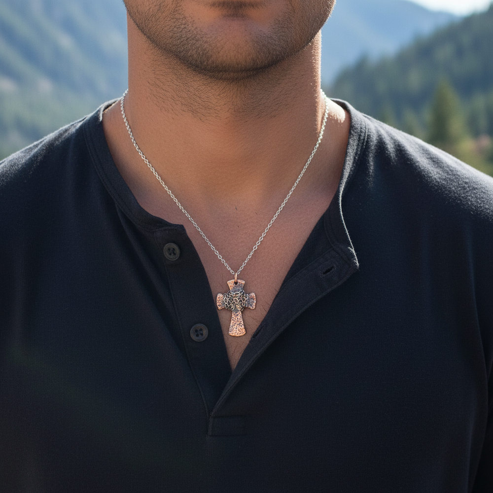 Male model wearing small hammered copper cross necklace - chest close-up