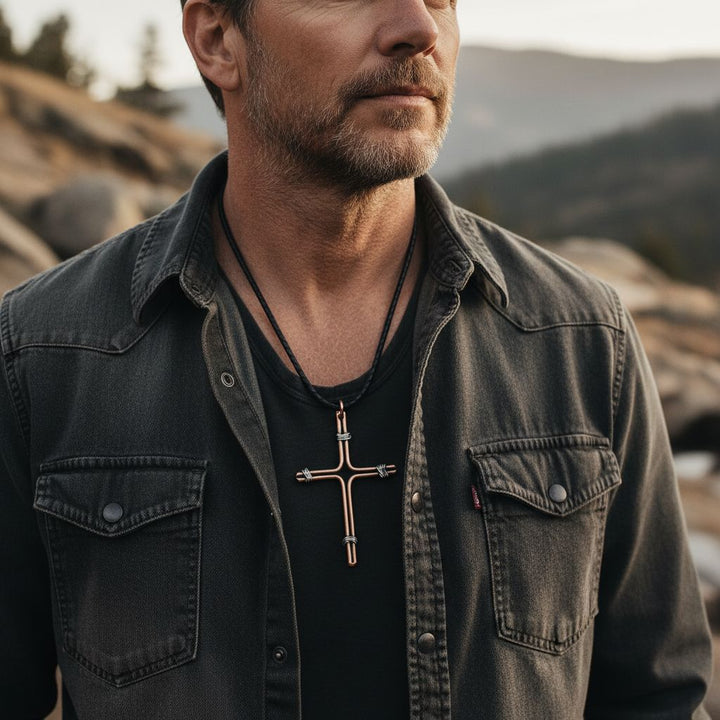 Handmade Large Copper and Silver Wire Cross Necklace for Men worn by a man outdoors.