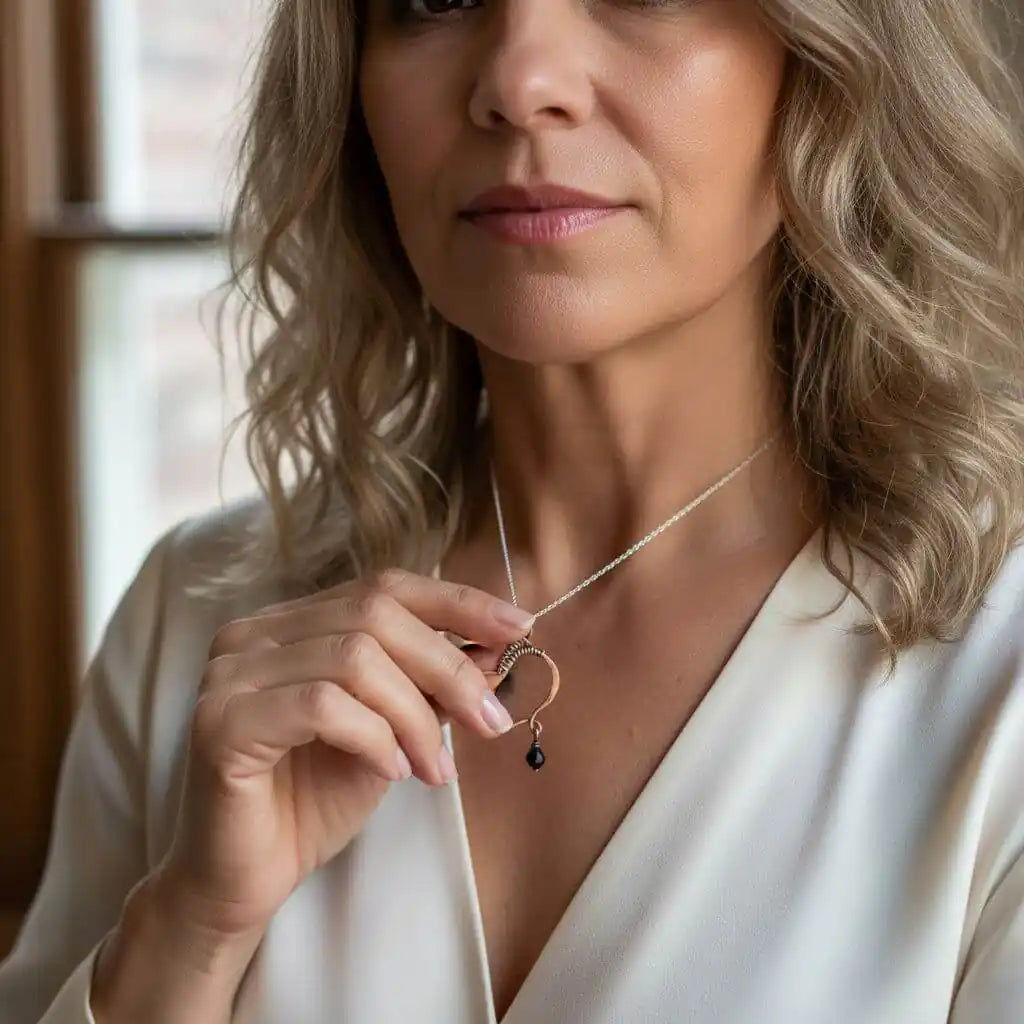 Woman wearing a Hammered Copper Butterfly Wing Child Abuse Survivor Necklace with black Swarovski crystal.