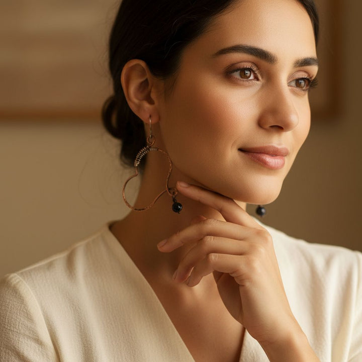 Sculpted Copper Butterfly Wing Abuse Survivor Earrings showcased on a model, highlighting the intricate design and elegance.