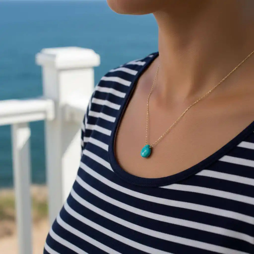 Gold Filled Aqua Jade Wire Wrap Gemstone Drop Necklace worn by a model near the ocean, showcasing its delicate design.