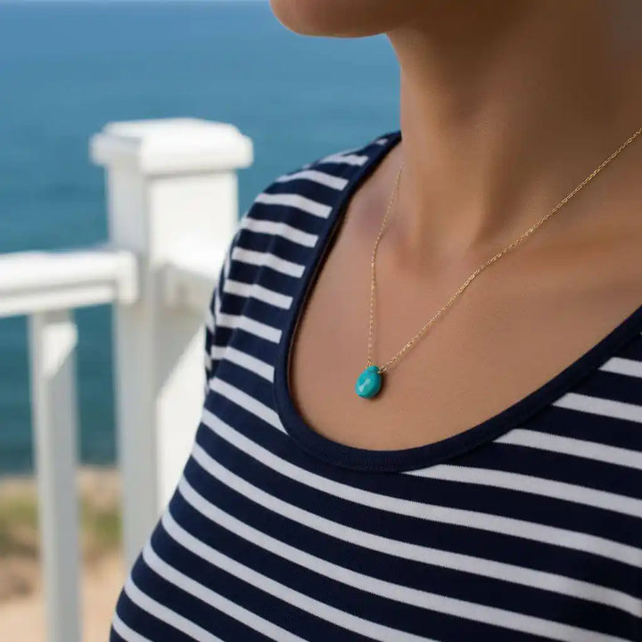 Gold Filled Aqua Jade Wire Wrap Gemstone Drop Necklace worn by a model near the ocean, showcasing its delicate design.