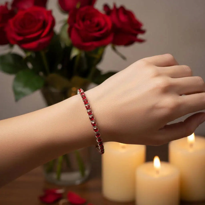 Wire Wrapped Red Crystal Tennis Bracelet Bangle worn on a hand, with red roses and candles in the background.