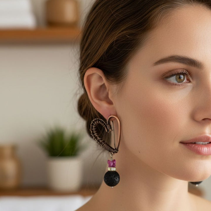 Copper Sculpted Heart Hoop Crystal Butterfly Lava Rock Earrings worn by model showcasing artisan design.