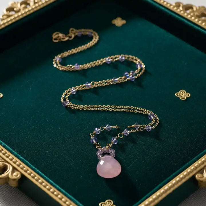 Purple Chalcedony Drop 14 KT Gold Filled Gemstone Necklace displayed on a velvet surface with elegant gold accents.