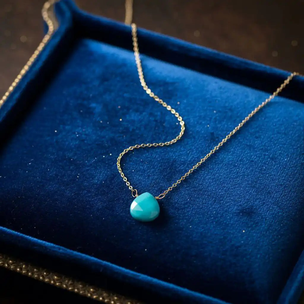 Gold Filled Aqua Jade Wire Wrap Gemstone Drop Necklace on a blue velvet background.