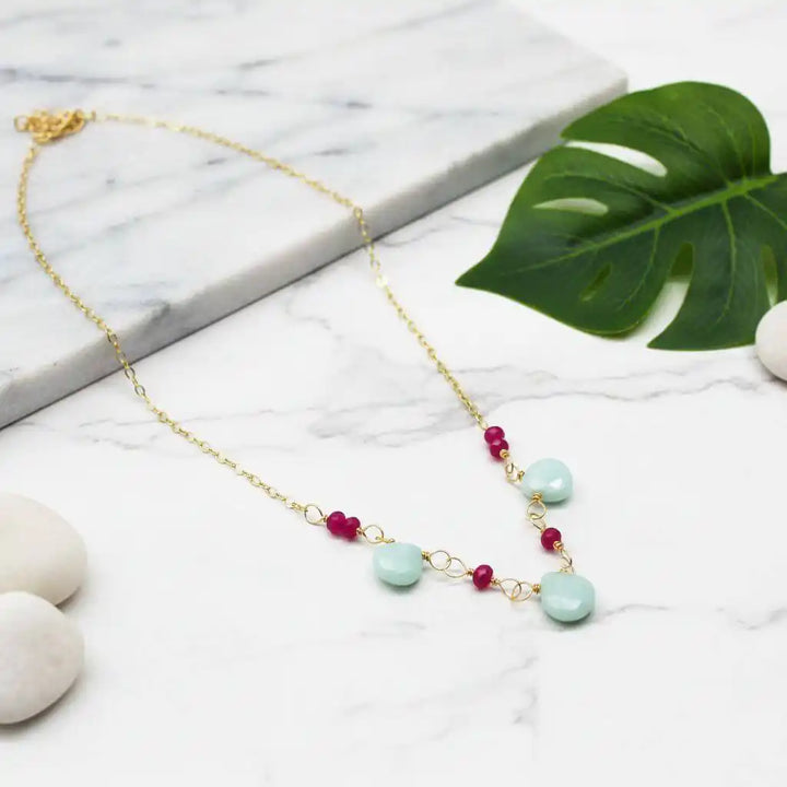 Dainty Gold Chain Mint and Hot Pink Gemstone Necklace with mint amazonite and hot pink chalcedony on marble background.