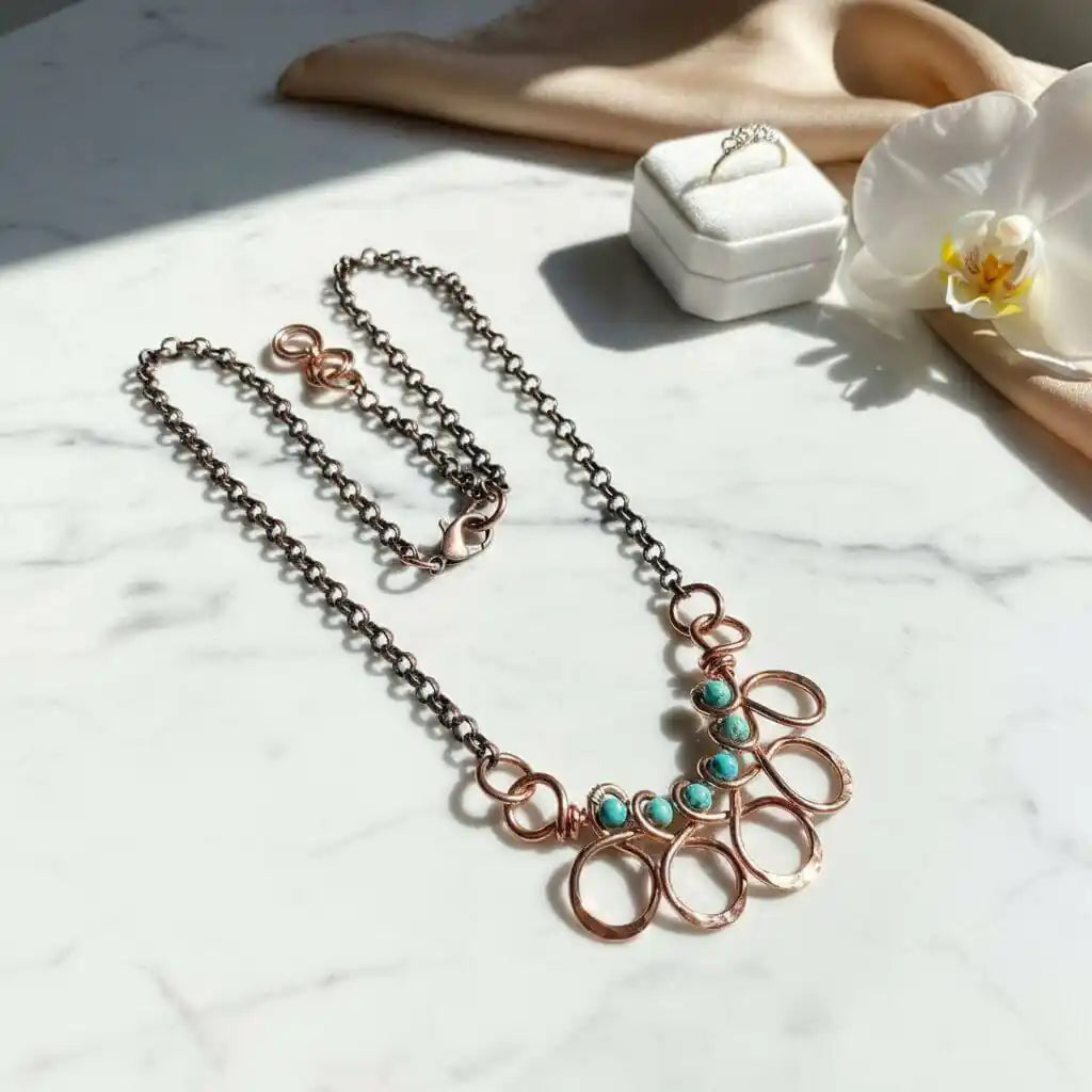 Seen on Ashley Liao Copper Turquoise Wire Wrapped Necklace displayed on marble surface with orchid and jewelry box.