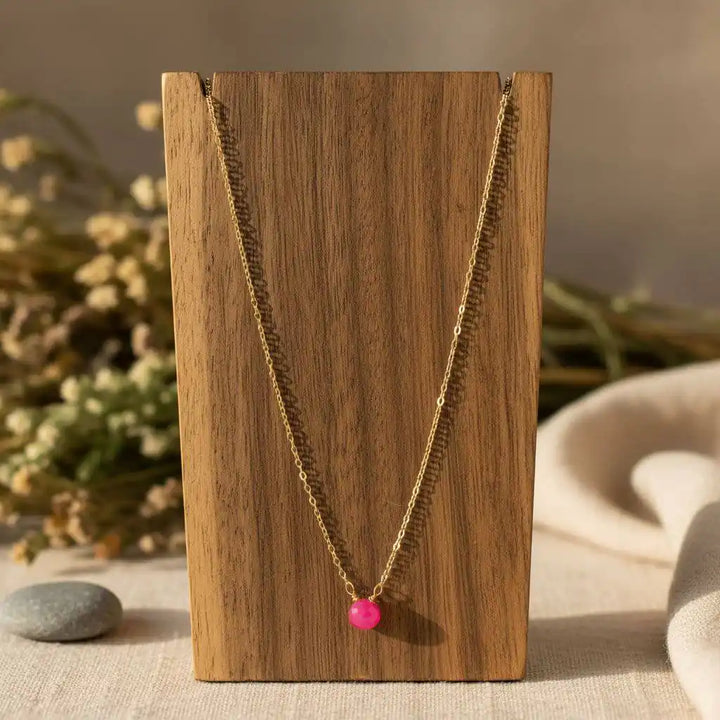 Tiny Hot Pink Chalcedony Gold Filled Necklace displayed on wooden stand with a vibrant hot pink chalcedony drop.