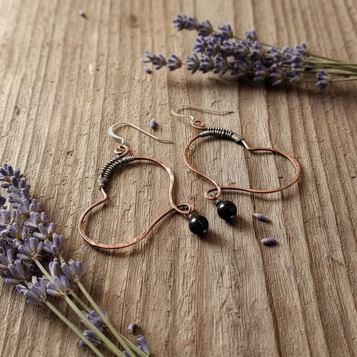 Sculpted Copper Butterfly Wing Abuse Survivor Earrings featuring copper hoops and black Swarovski crystal dangles.