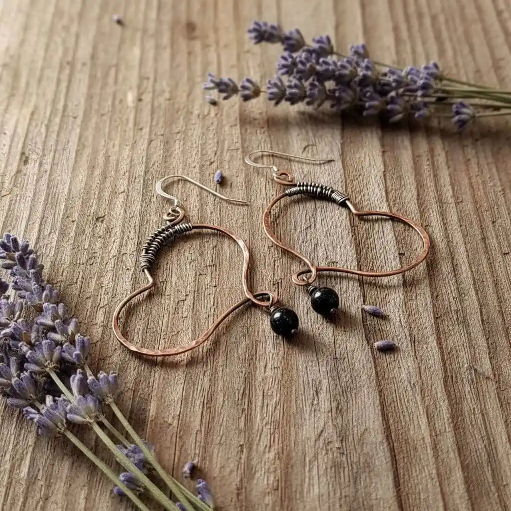 Sculpted Copper Butterfly Wing Abuse Survivor Earrings featuring copper hoops and black Swarovski crystal dangles.