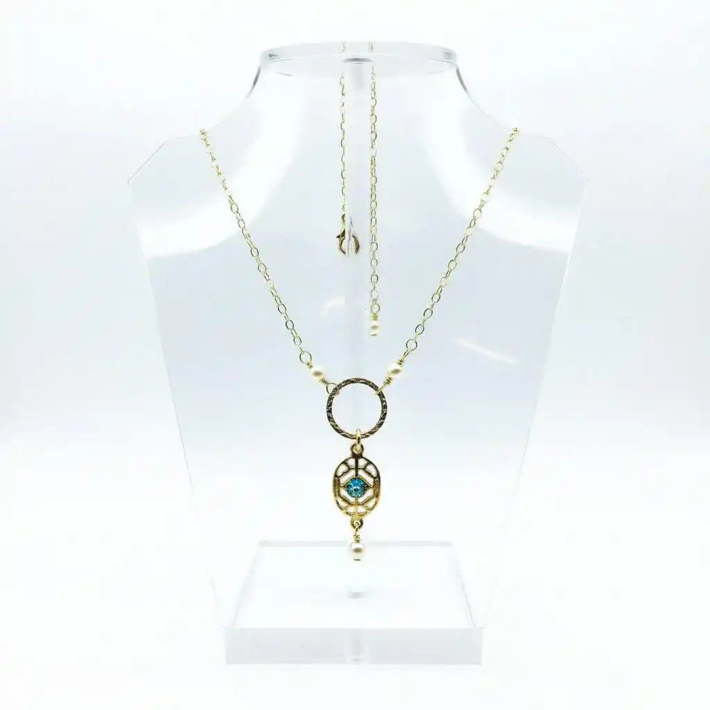 14 K Gold-Filled Hammered Open Circle Filigree Necklace displayed on a clear jewelry stand.