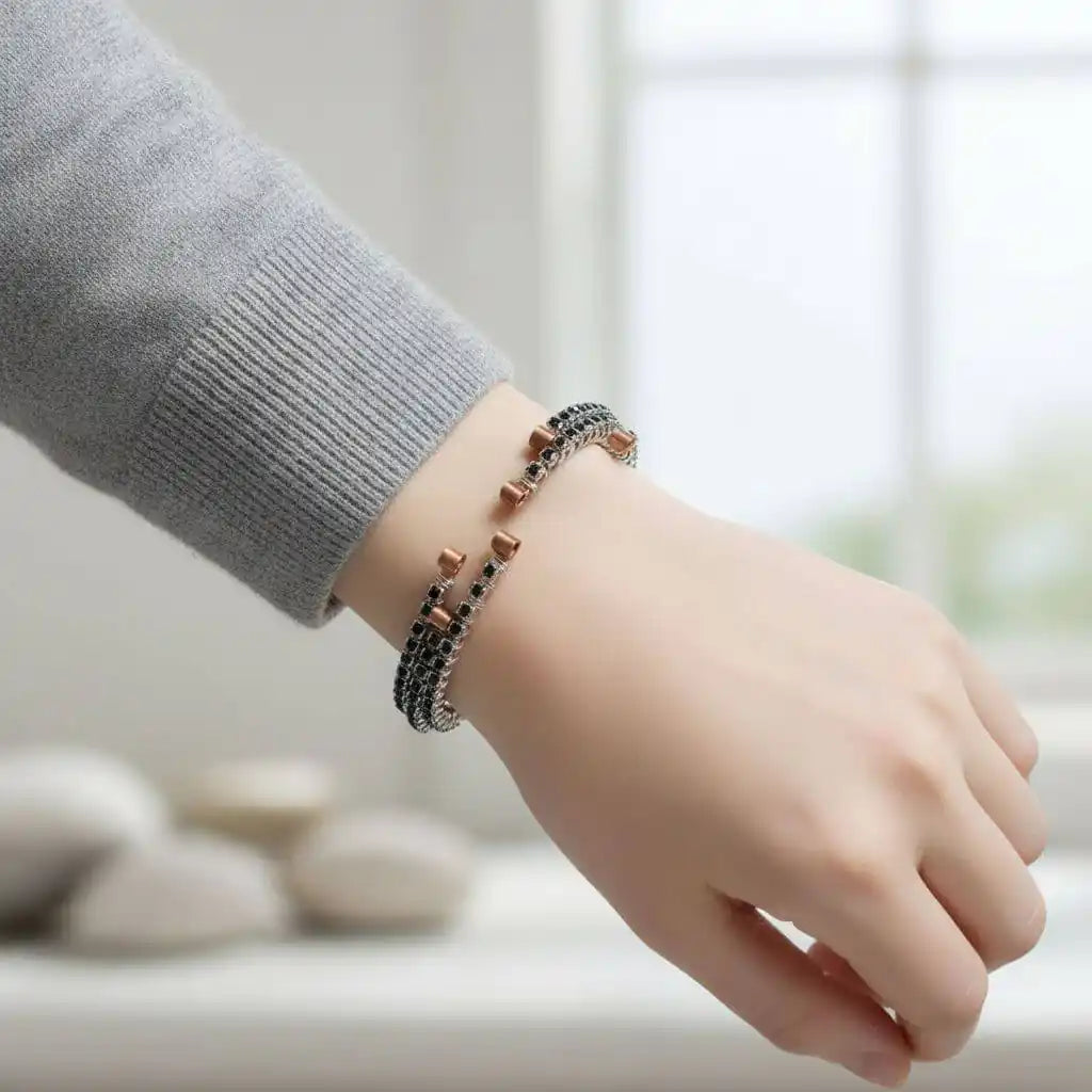 Wire Wrapped Copper Silver Black Crystal Rhinestone Bangle worn on a hand, showcasing its elegant design and sparkling rhinestones.