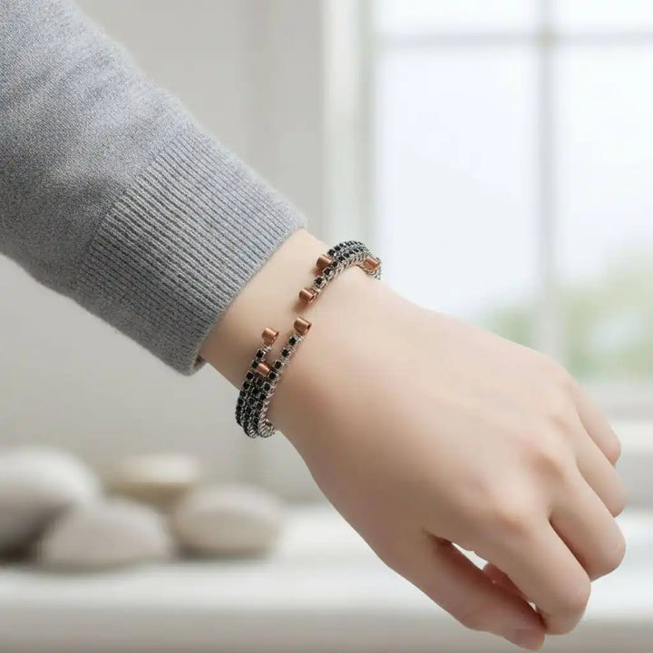 Wire Wrapped Copper Silver Black Crystal Rhinestone Bangle worn on a hand, showcasing its elegant design and sparkling rhinestones.