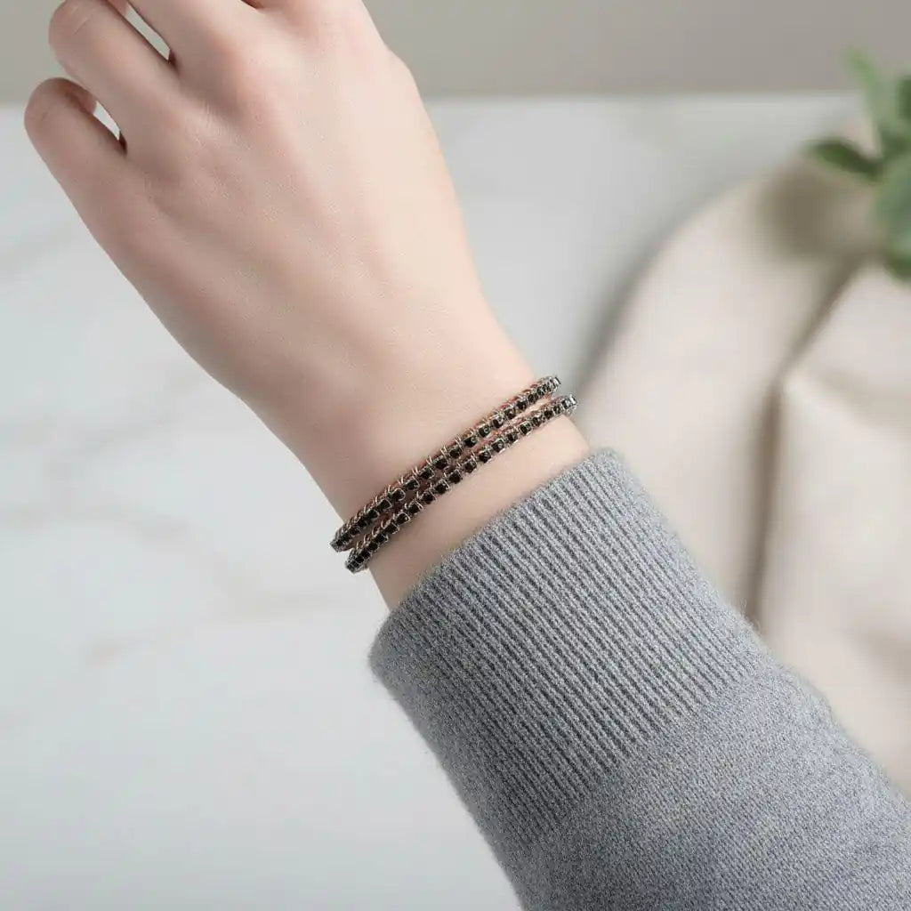 Wire Wrapped Copper Silver Black Crystal Rhinestone Bangle worn on a wrist with a gray sweater.