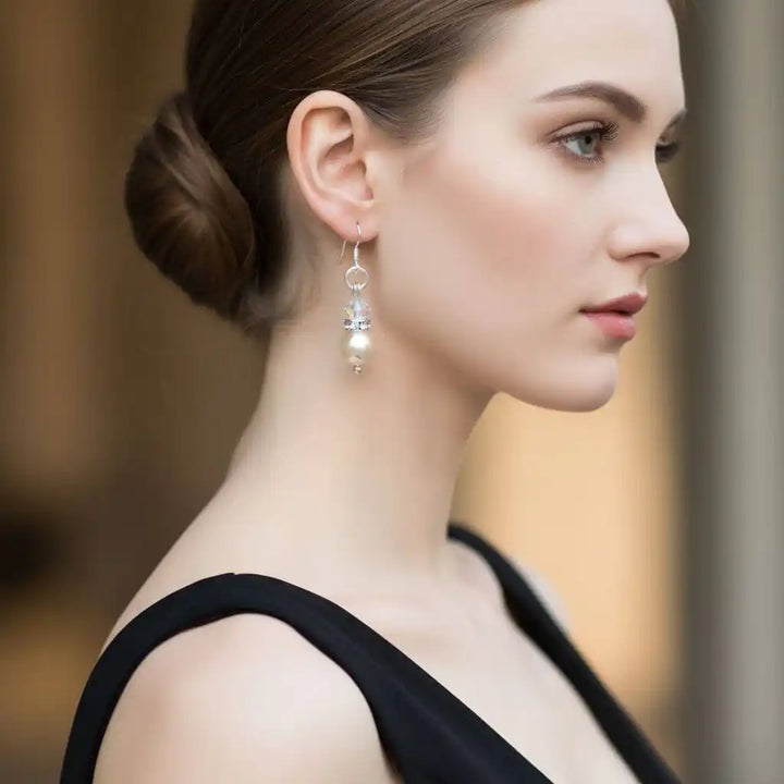 A woman wearing Various Color Swarovski Crystal Pearl Stack Earrings, showcasing elegance and sophistication.
