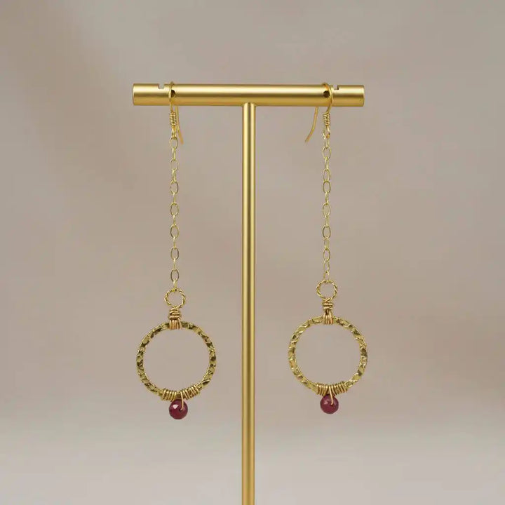 Gold Filled Wrapped Pink Chalcedony Open Circle Earrings hanging on display stand.