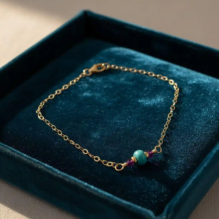 14K Gold Filled Pink and Turquoise Gemstone Dainty Bracelet displayed on a velvet box.