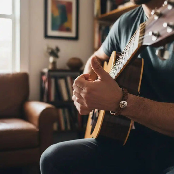 Large Mens Tree of Life Earth Color Macrame Leather Bracelet worn while playing guitar in a cozy living room.
