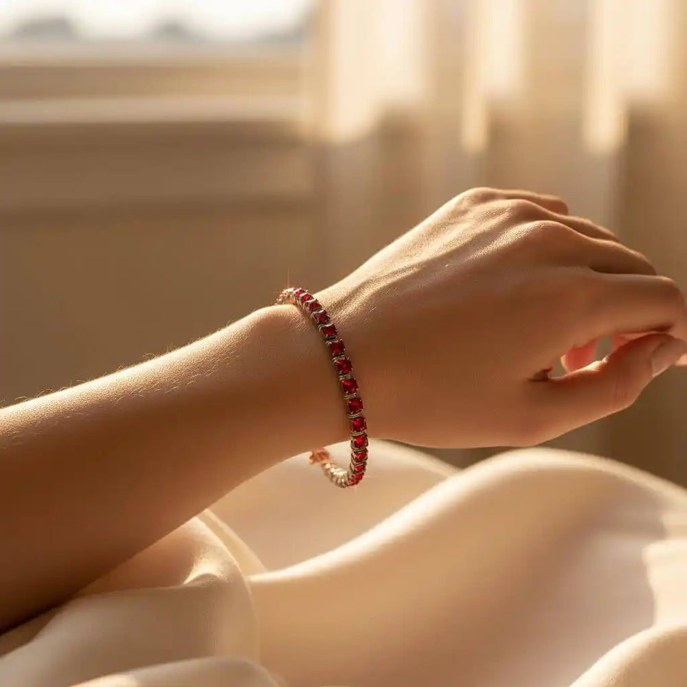Wire Wrapped Red Crystal Tennis Bracelet Bangle elegantly displayed on a hand with soft lighting.