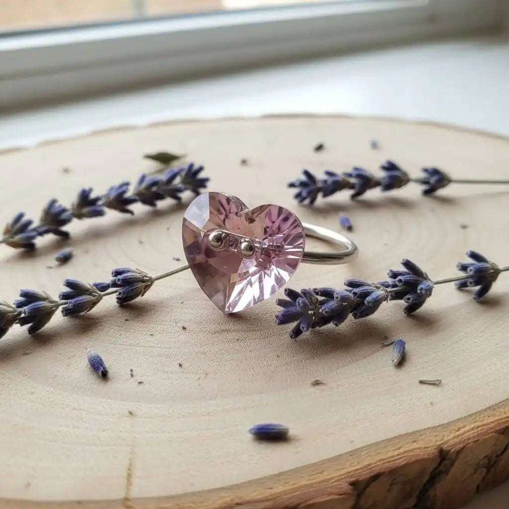 Big Girl Large Light Purple I LOVE YOU Heart Bling Ring surrounded by lavender on a wooden surface.