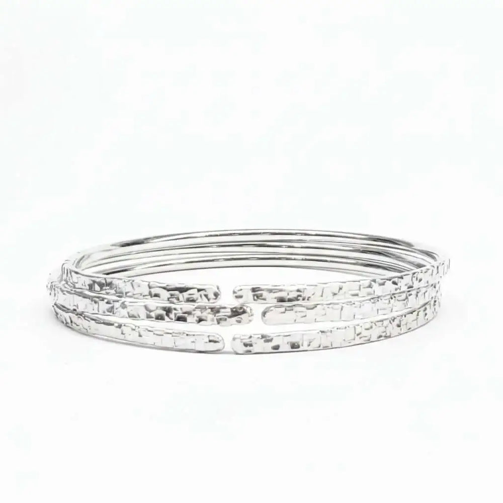 10 Gauge 925 Silver Hammer Textured Bangle showcasing a shimmering, intricate design with a hammered finish.