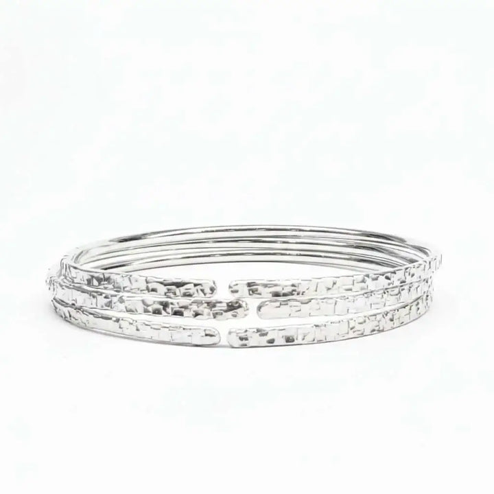 10 Gauge 925 Silver Hammer Textured Bangle showcasing a shimmering, intricate design with a hammered finish.