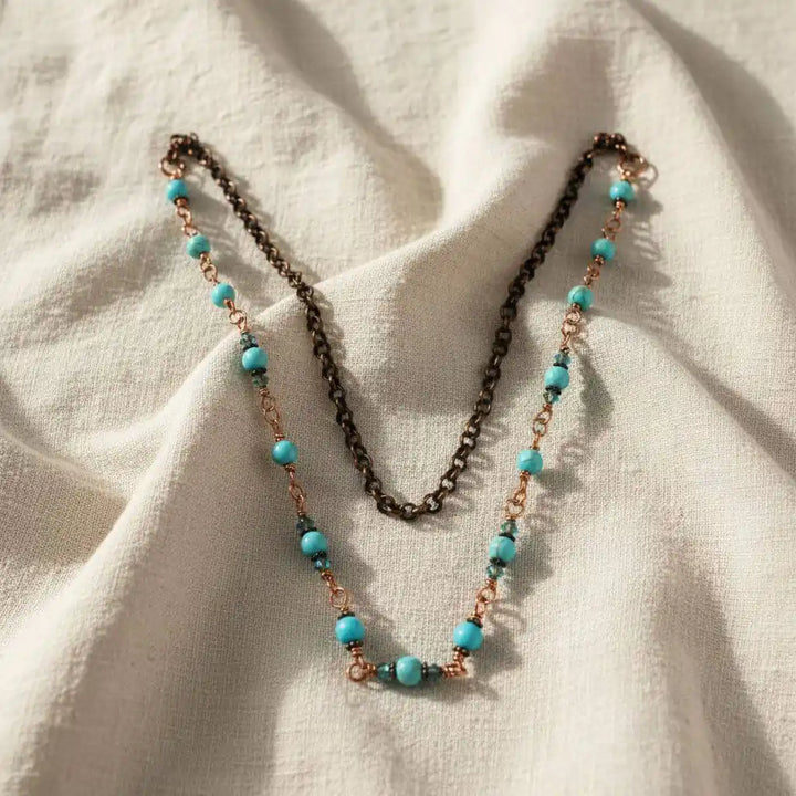 Wire Wrapped 24 Inches Copper Turquoise Necklace displayed on a soft fabric background.